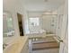 Bright bathroom with tub and shower, tiled walls, glass door, and elegant fixtures create a spa-like experience at 150 Holden Way, Woodstock, GA 30189