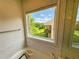 Bathroom view showcasing a tub by a large window overlooking beautiful outdoor scenery and tiled surround at 150 Holden Way, Woodstock, GA 30189