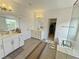 Elegant bathroom featuring double sinks, glass shower, tiled walls and flooring, and stylish lighting at 150 Holden Way, Woodstock, GA 30189