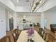 Open concept dining area flows into the bright kitchen with a large center island and stainless steel appliances at 150 Holden Way, Woodstock, GA 30189