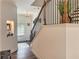 Inviting foyer features hardwood floors, staircase with black iron railings, and decor accents at 150 Holden Way, Woodstock, GA 30189