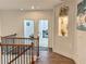 Open second floor hallway with hardwood floors and decorative niches at 150 Holden Way, Woodstock, GA 30189