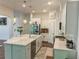 Bright kitchen features stainless steel appliances, large island, and plenty of cabinet space at 150 Holden Way, Woodstock, GA 30189