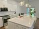 Bright kitchen features stainless steel appliances, large island, and plenty of cabinet space at 150 Holden Way, Woodstock, GA 30189