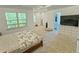 Bright main bedroom featuring plush carpeting, large windows, and ensuite bathroom entry for a relaxing retreat at 150 Holden Way, Woodstock, GA 30189