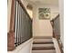 Hardwood staircase with wood and wrought iron banister leads to the upper level at 150 Holden Way, Woodstock, GA 30189