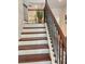Hardwood staircase with wood and wrought iron banister leads to the upper level at 150 Holden Way, Woodstock, GA 30189