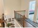 Hardwood staircase with wood banister and decorative artwork leads to the upper level at 150 Holden Way, Woodstock, GA 30189