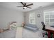 Bright bedroom with a ceiling fan, carpeted floors, and windows allowing for ample natural light at 855 Mountain View Nw Ter, Marietta, GA 30064
