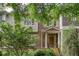 Charming brick townhome featuring a welcoming front porch and lush landscaping at 855 Mountain View Nw Ter, Marietta, GA 30064