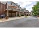 Row of townhomes with garage parking and elevated decks, offering neighborhood views and outdoor living space at 855 Mountain View Nw Ter, Marietta, GA 30064