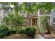 Brick townhome featuring a welcoming front porch, stone steps, and a meticulously maintained yard at 855 Mountain View Nw Ter, Marietta, GA 30064