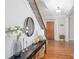 Warm foyer featuring hardwood floors, staircase with iron railing, and stylish console table at 855 Mountain View Nw Ter, Marietta, GA 30064
