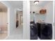 Hallway leading to a bathroom and laundry area with side by side washer and dryer, offering practical living spaces at 855 Mountain View Nw Ter, Marietta, GA 30064
