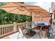 Outdoor patio with stylish furnishings, dining area, and umbrella with wooded view at 855 Mountain View Nw Ter, Marietta, GA 30064