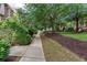Paved pathway showcasing mature trees, lush greenery, and manicured lawns in a serene community setting at 855 Mountain View Nw Ter, Marietta, GA 30064