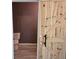 An en-suite bathroom is accessed through a sliding barn door and features a toilet and tile floor at 112 Brown Se Ave, Atlanta, GA 30315