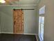 This bedroom features a wood, sliding barn-door closet and a window with views of the lawn at 112 Brown Se Ave, Atlanta, GA 30315