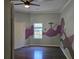 Cozy bedroom with painted wall art and ceiling fan at 112 Brown Se Ave, Atlanta, GA 30315
