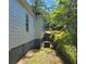 This shows the exterior of the home with well-maintained siding and access to the backyard with ample foliage at 112 Brown Se Ave, Atlanta, GA 30315