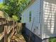 Side view of a home, showcasing its exterior, fencing, and utility connections on the side of the house at 112 Brown Se Ave, Atlanta, GA 30315