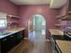 Charming kitchen featuring stylish countertops, modern appliances, open shelves, and an archway to the living room at 112 Brown Se Ave, Atlanta, GA 30315