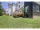 Expansive backyard view featuring a wooden deck, green lawn, and modern home exterior, perfect for outdoor living at 1410 Lavista Ne Rd, Atlanta, GA 30324