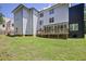 Wide backyard view showing a spacious lawn, a wooden deck attached to a modern two-story home with sleek design at 1410 Lavista Ne Rd, Atlanta, GA 30324