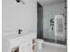 Modern bathroom with a glass shower, black hardware, and white cabinets at 1410 Lavista Ne Rd, Atlanta, GA 30324
