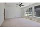 Bright bedroom featuring large windows, a modern ceiling fan, and neutral walls, creating a serene atmosphere at 1410 Lavista Ne Rd, Atlanta, GA 30324