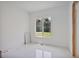 Bright bedroom with a large window overlooking the backyard and new floors at 1410 Lavista Ne Rd, Atlanta, GA 30324