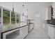 Modern kitchen featuring white cabinets, black countertops, and a large window overlooking the backyard at 1410 Lavista Ne Rd, Atlanta, GA 30324