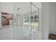 Modern living room with large windows and glass walls overlooking other rooms of the house at 1410 Lavista Ne Rd, Atlanta, GA 30324