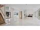 Bright open living room showing stairs, foyer, and an opening to the kitchen area with stainless appliances at 1410 Lavista Ne Rd, Atlanta, GA 30324
