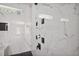 Modern shower design featuring marble tile and multiple shower heads at 1410 Lavista Ne Rd, Atlanta, GA 30324