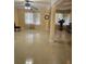 Open living room with large windows, ceiling fan, and neutral tiled flooring at 2379 Manassas Ln, Decatur, GA 30034