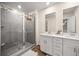 Modern bathroom with glass-enclosed shower, double vanity, and elegant fixtures at 2440 Rocky City Ln, Snellville, GA 30078