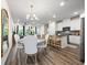 Bright, open-concept dining area features modern lighting and connects seamlessly to the kitchen with breakfast bar at 2440 Rocky City Ln, Snellville, GA 30078