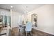Inviting dining area with a table set for four, featuring a stylish chandelier and a decorative mirror at 2440 Rocky City Ln, Snellville, GA 30078