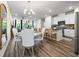 Bright, open-concept dining area features modern lighting and connects seamlessly to the kitchen with breakfast bar at 2440 Rocky City Ln, Snellville, GA 30078