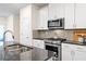 Well-equipped kitchen with granite countertops, stainless steel appliances, and ample cabinet space at 2440 Rocky City Ln, Snellville, GA 30078