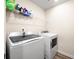 Bright laundry room with a modern washer and dryer and ample shelving for storage at 2440 Rocky City Ln, Snellville, GA 30078