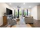 Bright living area with large windows, ceiling fan, and seamless connection to the outdoors at 2440 Rocky City Ln, Snellville, GA 30078
