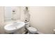 Powder room with pedestal sink, modern faucet, and decorative wall shelf at 2440 Rocky City Ln, Snellville, GA 30078