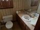 Traditional bathroom features a sink, toilet, and floral wallpaper at 108 Fair Oaks Se Dr, Conyers, GA 30094