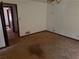 Empty bedroom with an open door to another room and outdated carpet at 108 Fair Oaks Se Dr, Conyers, GA 30094