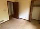 Empty bedroom features two closets, an open door, and outdated carpet at 108 Fair Oaks Se Dr, Conyers, GA 30094