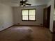 Spacious bedroom features a ceiling fan and window overlooking the yard at 108 Fair Oaks Se Dr, Conyers, GA 30094