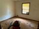 Vacant bedroom has outdated carpet and a window overlooking the outdoors at 108 Fair Oaks Se Dr, Conyers, GA 30094