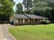Traditional single-story home with red shutters and a covered front porch at 108 Fair Oaks Se Dr, Conyers, GA 30094